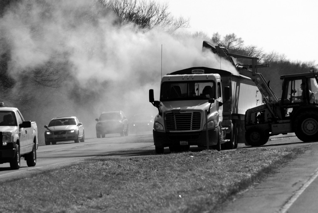 Toxic coal ash dust billows over northbound vehicles and nearby homes during cleanup following a crash on Illinois Route 29 that closed the southbound lanes for hours. A semi-trailer truck transporting coal fly ash crashed with a garbage truck on March 27. Photo by Clare Howard