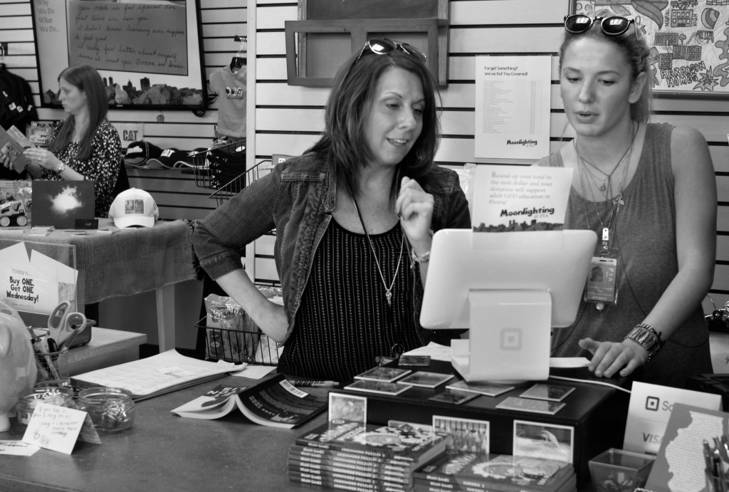 Photo by Clare Howard  Hedy Elliott-Gardner, left, reviews sales with Vail Olinger at the Moonlight Coalition gift shop at the General Wayne A. Downing Peoria International Airport. All profits from the shop go to covering costs for the Moonlight Coalition for Adult Learning GED program. 