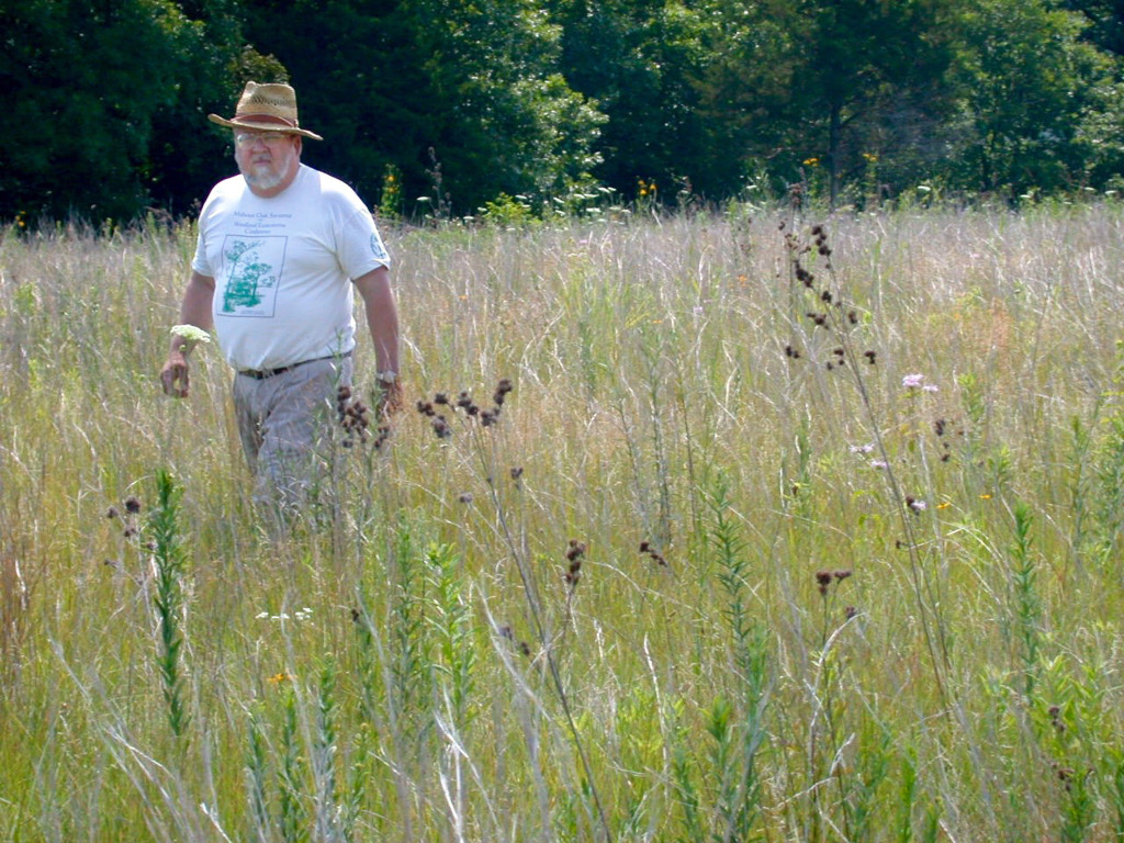 In this 2002 photo taken by Mike Miller, Maury Brucker walks through a restored prairie on land he and Emiko Yang recently gave to Peoria Audubon Society. Yang, seen in portrait photo, and Brucker worked on the 22-acre tract for more than 20 years restoring the high quality prairie and savanna. They had the land designated an Illinois State Nature Preserve to provide legal protection in perpetuity.