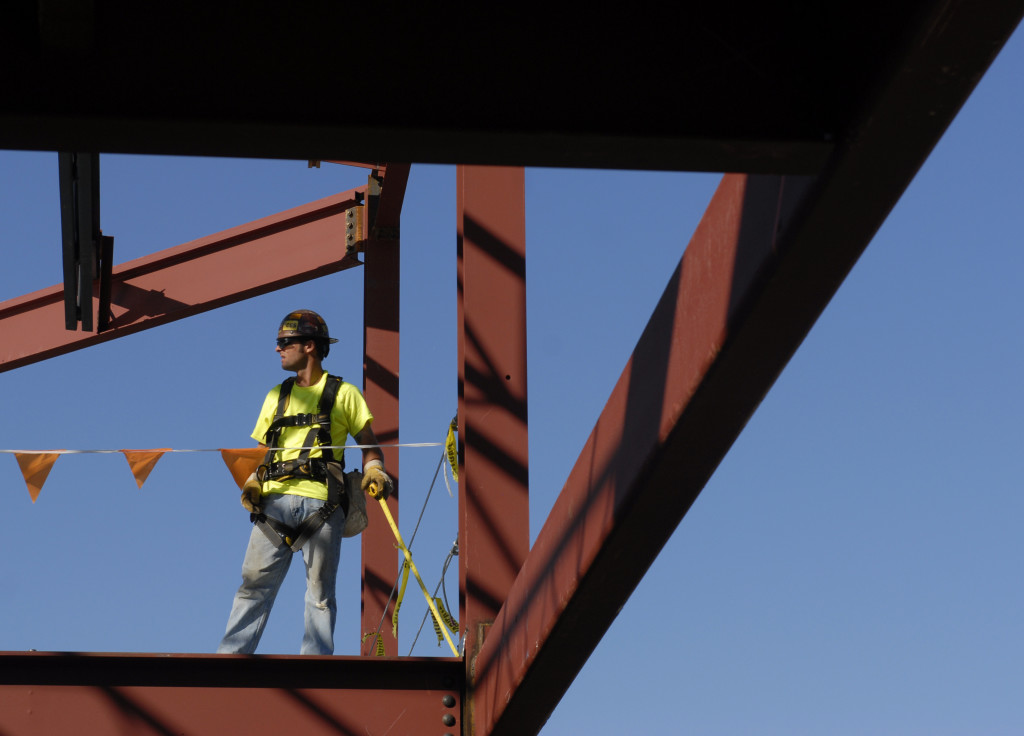 PHOTO BY CLARE HOWARD Joseph Reising, member of Iron Workers Local 112, stands on an upper floor of the $10 million RLI Corp. expansion. In planning its project, RLI Corp. knew it wanted skilled trades for a high quality job. General contractor is P.J. Hoerr. RLI corporate headquarters will ultimately be a campus-like setting with several buildings connected with walkways. 