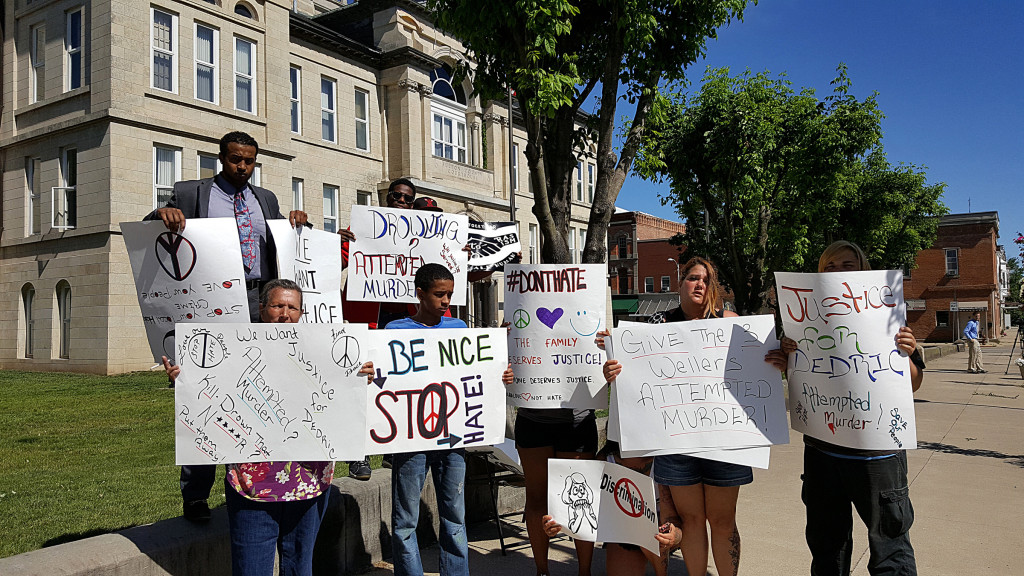 PHOTO BY BILL KNIGHT A small group demonstrates outside the Fulton County Courthouse June 29 while people accused of a hate crime appear at a preliminary hearing. 