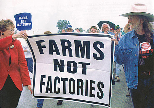 Karen Hudson marches with Willie Nelson at Farm Aid 2005 in Tinley Park, Ill.
